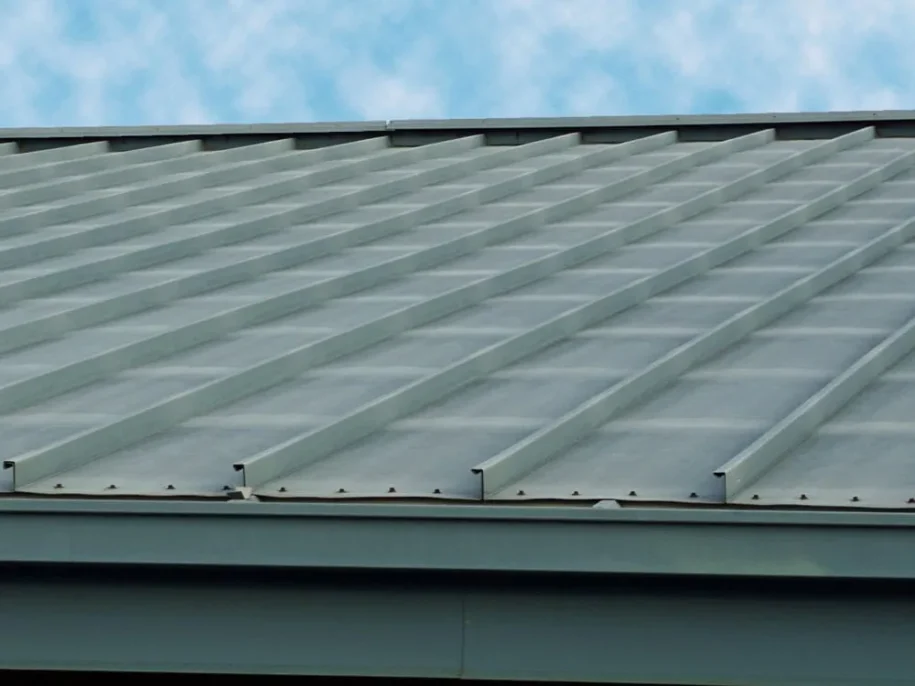 Close-up of a standing seam metal roof, showcasing durable and energy-efficient metal roofing solutions by Roof Dudes Midwest. Experts in metal roof installation for residential and commercial properties, providing long-lasting protection and modern style.