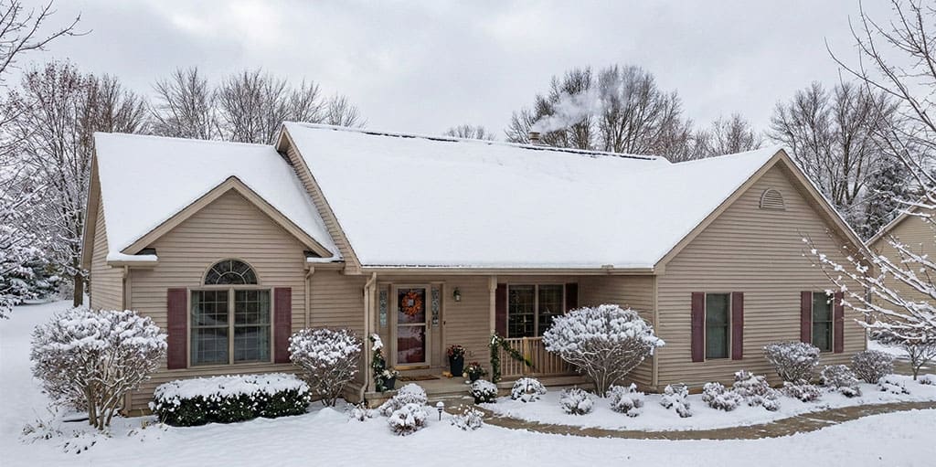 Residential home with a properly sealed roof in winter, supporting energy efficiency and indoor heat retention.